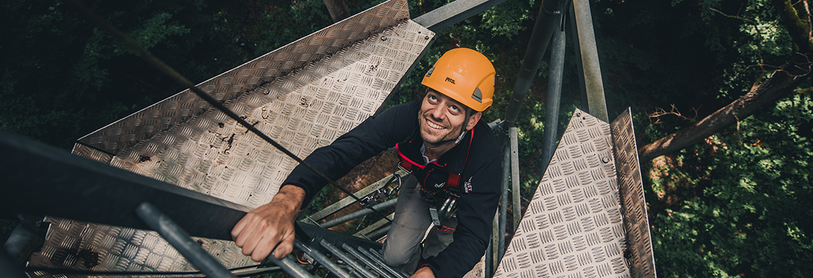 Man climbing tall tower