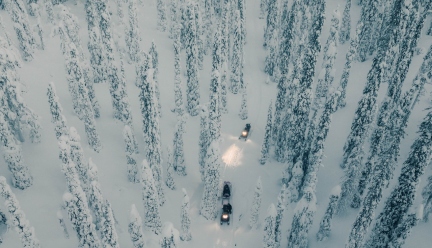 scientists driving snow mobiles in the Finnish Lapland